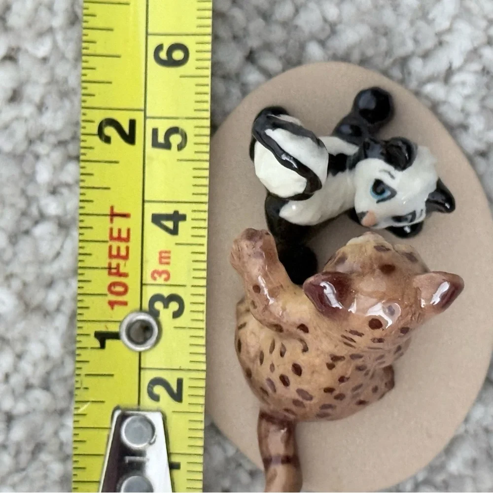 Vintage retired Hagen Renaker bobcat and skunk babies on base